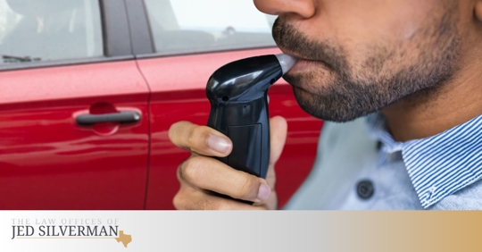 Man taking a breath test to determine BAC